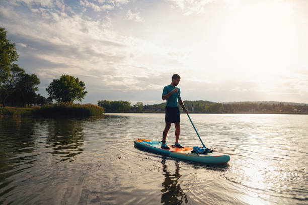istock During sunset, young man, paddleboarding with standup paddleboard on a lake 1429986536