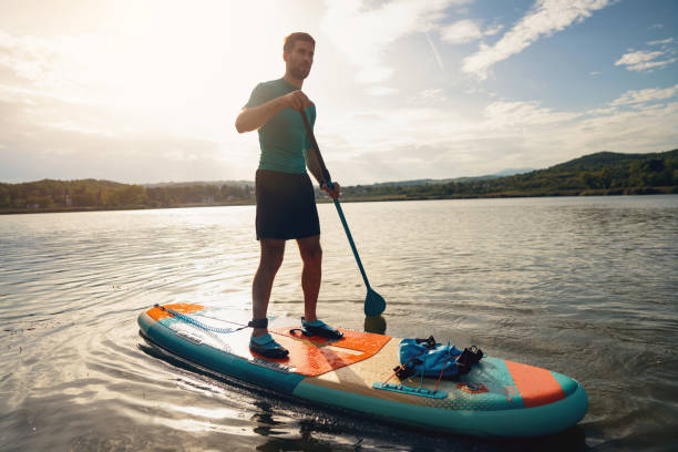 istock During sunset, young man, paddleboarding with standup paddleboard on a lake 1429986642