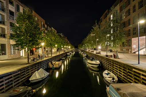 Copenhagen, Denmark  A canal with boats in the Nyhavn or New Harbor district at night.