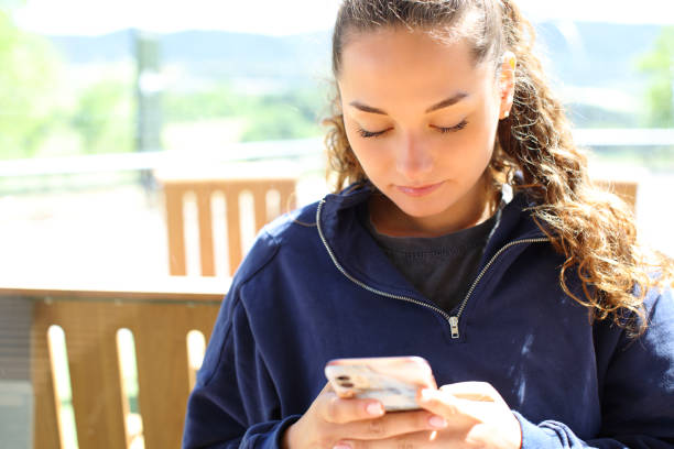 istock Concentrated woman using smart phone in a restaurant terrace 1429989565