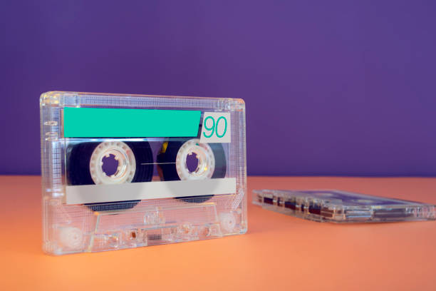 Close up vintage audio casette on 90's color theme background Close up vintage audio casette on 90's color theme background. Retro cassette concept. 70s theme stock pictures, royalty-free photos & images
