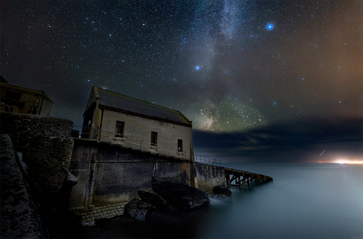 The abandoned lifeboat station in front of the Milky Way.