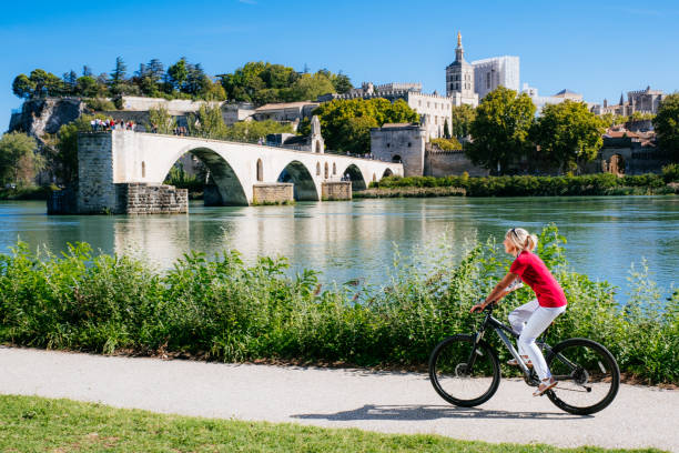 ciclismo de verão ao lado de pont saint benezet, avignon, frança - rhone bridge - fotografias e filmes do acervo