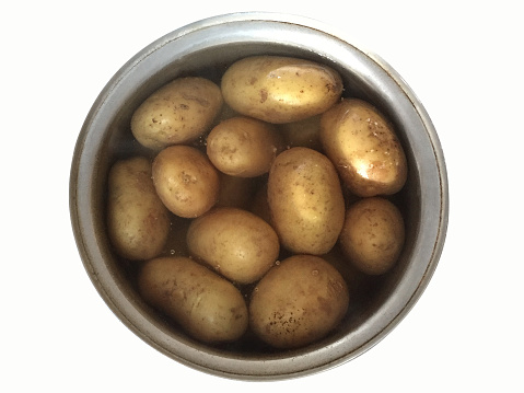 High angle view potatoes in a pot of water isolated on the white background with clipping path