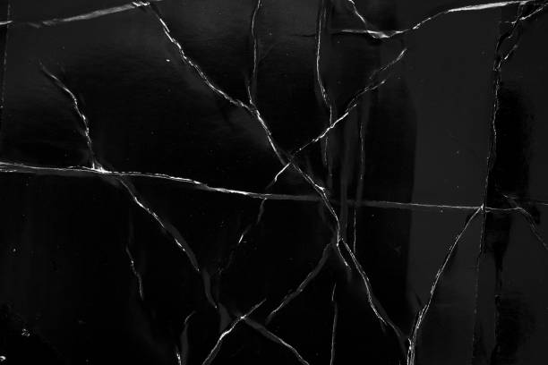 istock Black damaged cardboard paper overlay texture background 1429998569
