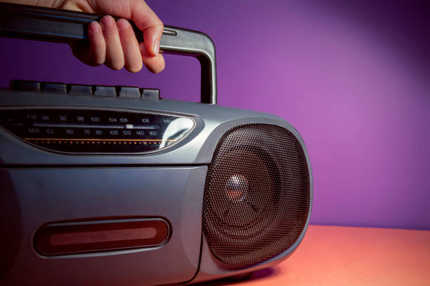 istock A hand holding stereo tape deck speaker. 90's color theme 1429998587