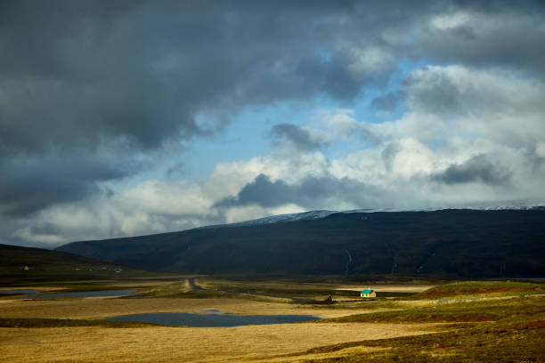 Landscape with small isolated house at sunset, South West Iceland