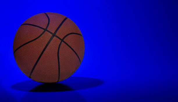 istock Basket ball on blue light abstract background with copy space 1430001285