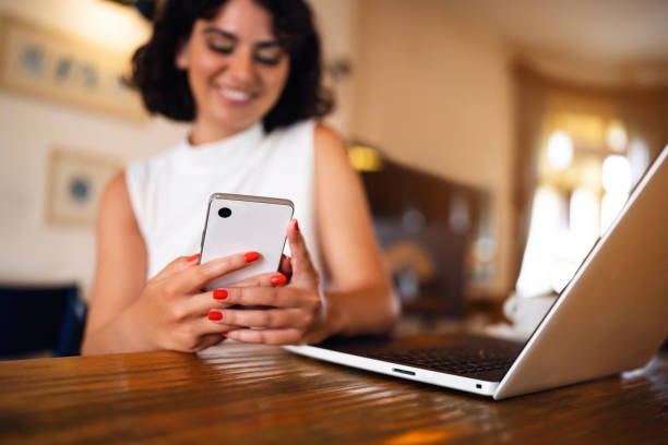 istock Caucasian businesswoman using mobile phone while working at the coffee shop 1430001916
