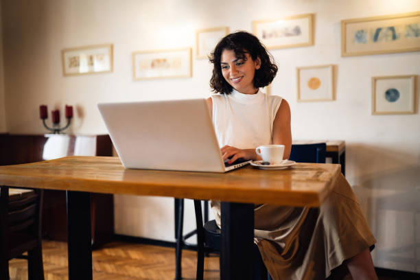 istock Young woman working on laptop from the modern coffee shop 1430002421