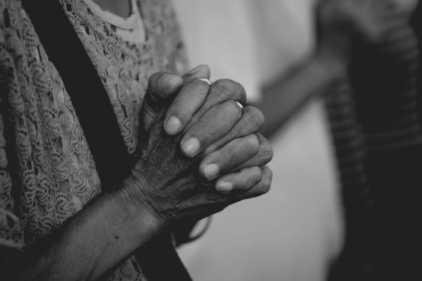 Woman hand praying together at Church. stock photo