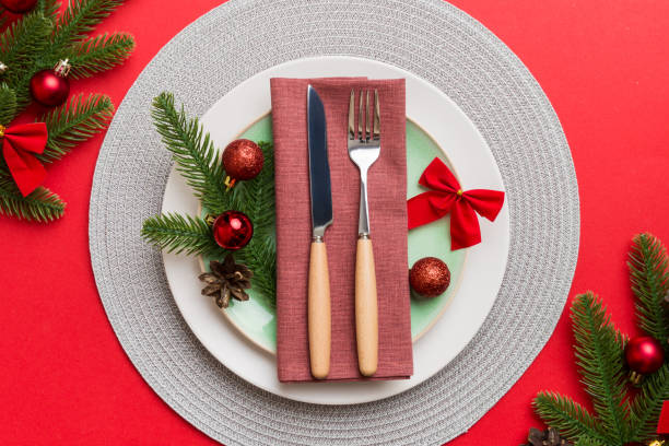 istock Christmas table place setting with christmas decor and plates, kine, fork and spoon. Christmas holiday background. Top view 1430004742