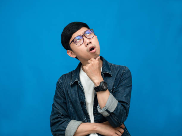istock Young man jeans shirt thoughtful looking above 1430008311
