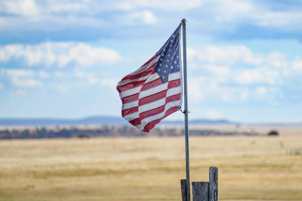 istock American Flag in Front of Clouds 1430010139