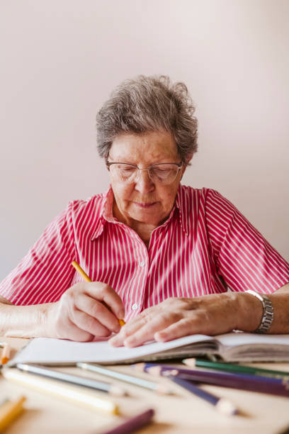 istock grandmother drawing with colored pencils 1430010164