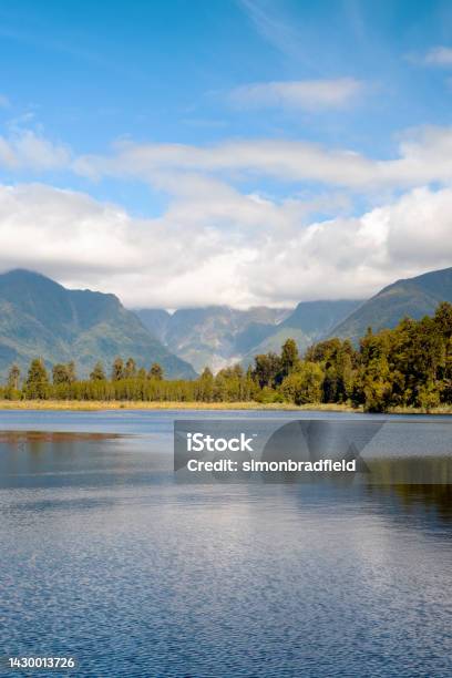 Lake Matheson On New Zealands South Island Stock Photo - Download Image Now - Beauty In Nature, Cloud - Sky, Color Image