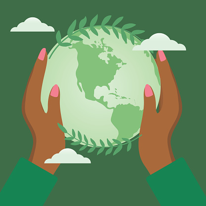 Human hands holding a globe with leaves. Environmental concept on in shades of green.
