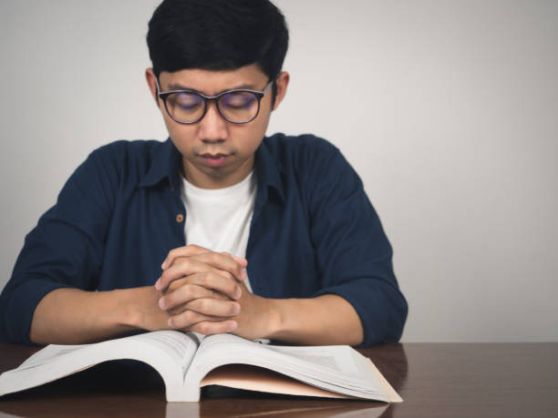 istock Man wear glasses joy hands wish to pass testing at table 1430015587