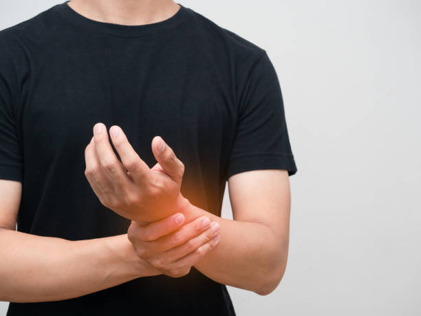 istock Close up man pain his wrist isolated studio shot 1430016197