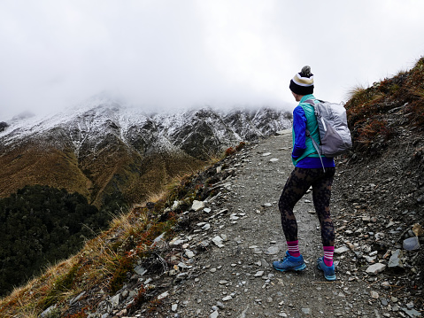 Woman hiking high above Queenstown, New Zealand.