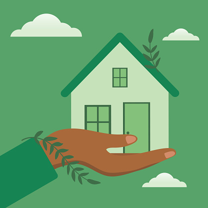 Hand Holding A Green Home. Sustainability Concept.