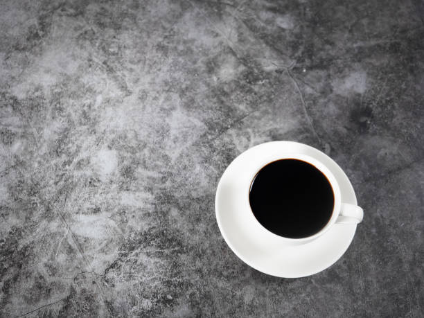 istock Black coffee in cup top view copy space dark background 1430019417