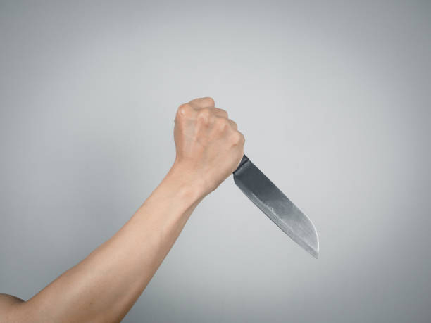 istock Murder hand holding shiny knief isolated 1430019431