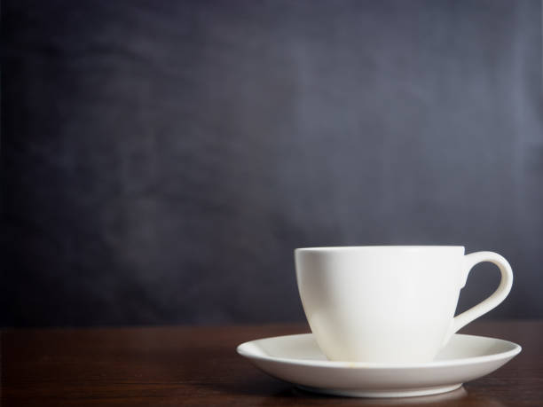 istock Close up white coffee cup on wood table dark background 1430019468