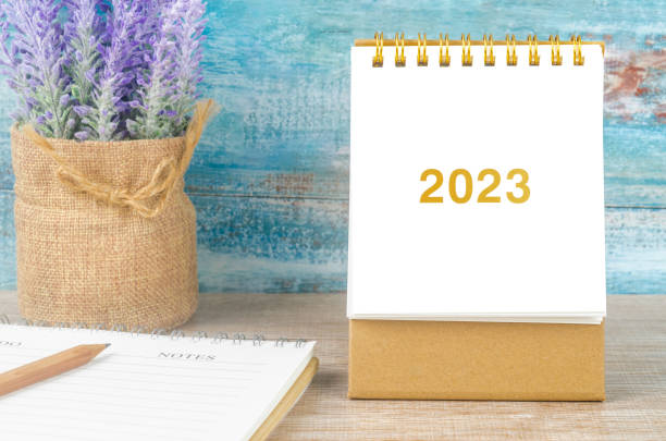 istock The 2023 Desk calender with Note Book on wooden background. 1430019491