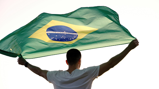 Young man with Brazilian flag.