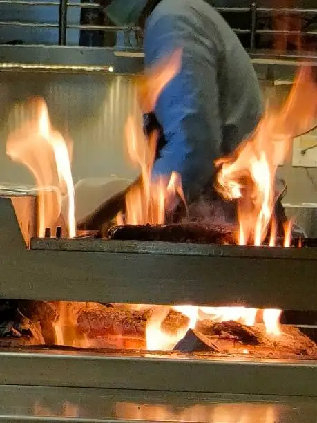 This dramatic beef grilled surrounding by fire, taken place in fancy restaurant in jakarta, the busiest town in indonesia
