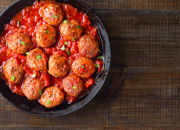 Fried meatballs with tomato sauce stock photo