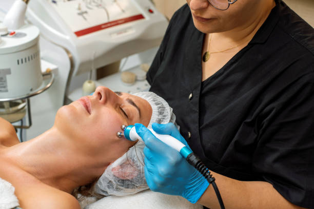 istock Expert dermatologist applying electrical stimulation to woman's face 1430025282