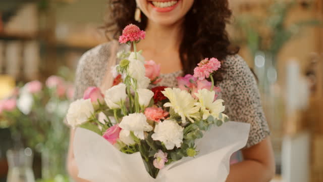 Portrait of young woman working in a flower shop.