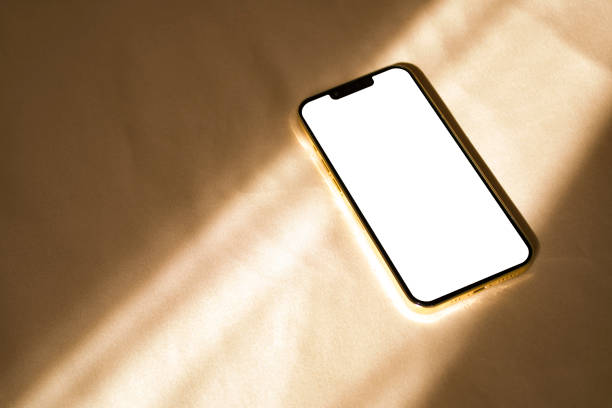 istock Phone mockup with sunlight shadows on beige background 1430031516