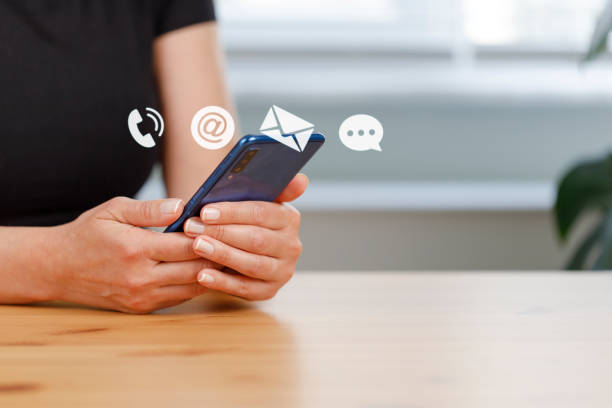 istock Woman using smart phone with the email, phone, address, chat message icons. 1430031784
