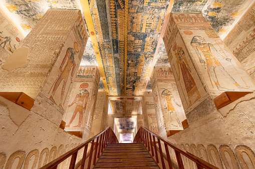 Valley of the Kings, Luxor, Egypt - July 22, 2022: The tomb of Ramses V and Ramses VI is also known as KV9. Tomb KV9 was originally constructed by Pharaoh Ramesses V. He was interred here, but his uncle, Ramesses VI, later reused the tomb as his own.\n\nThe tomb has some of the most diverse decoration in the Valley of the Kings. Its layout consists of a long corridor, divided by pilasters into several sections, leading to a pillared hall, from which a second long corridor descends to the burial chamber.
