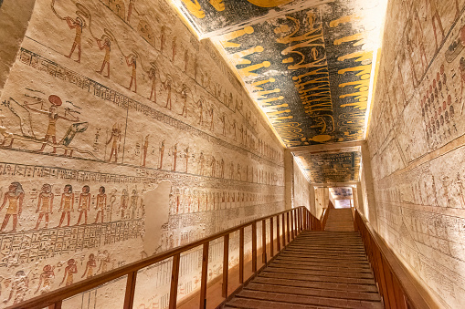 Valley of the Kings, Luxor, Egypt - July 22, 2022: The tomb of Ramses V and Ramses VI is also known as KV9. Tomb KV9 was originally constructed by Pharaoh Ramesses V. He was interred here, but his uncle, Ramesses VI, later reused the tomb as his own.

The tomb has some of the most diverse decoration in the Valley of the Kings. Its layout consists of a long corridor, divided by pilasters into several sections, leading to a pillared hall, from which a second long corridor descends to the burial chamber.