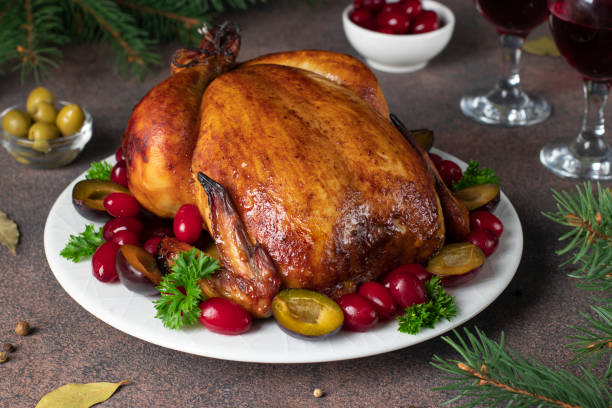 christmas baked chicken with plum, cornelian cherries, olives and parsley on brown background - plum fruit organic food and drink imagens e fotografias de stock