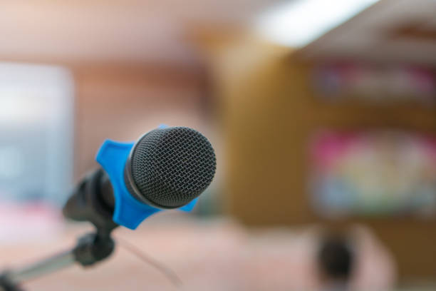 istock Public Microphone for speaking blure backgrounds, Close-up  microphone on stand for speaker speech in seminar room with Event light convention hall for Business meeting and Education 1430039581