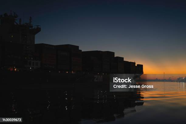 Cargo Ship At Sunset Stock Photo - Download Image Now - Beauty In Nature, Cargo Container, Color Image