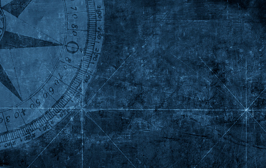 A compass rose on a dark blue textured background.