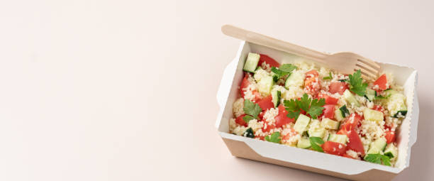 istock Healthy salad with couscous in cardboard container close up. 1430042771