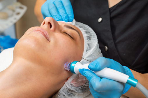 Expert Dermatologist Applying Facial Hydro Microdermabrasion Peeling Treatment