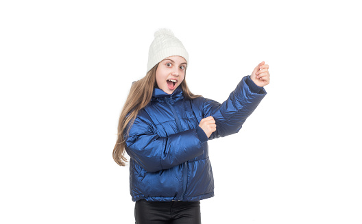 amazed child in knitted hat and puffer padded jacket warm clothes isolated on white, warm clothes.