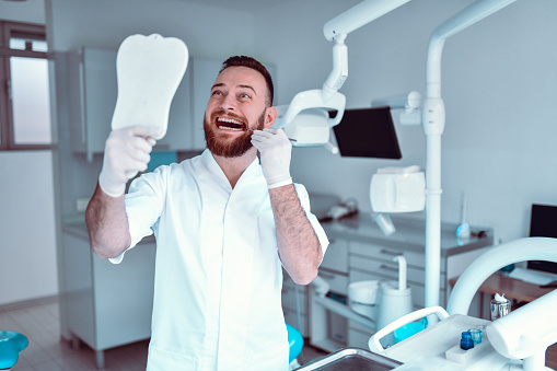 Daily Teeth Checkup By Bearded Male Dentist