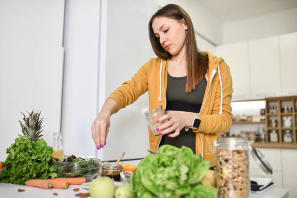 istock Happy Athletic Female Cooking On Her Home Kitchen 1430049225