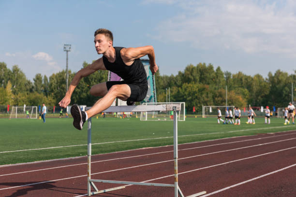 istock Young man athlete runnner running hurdles 1430050910