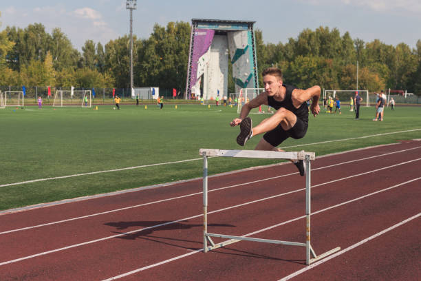 istock Young man athlete runnner running hurdles 1430051145