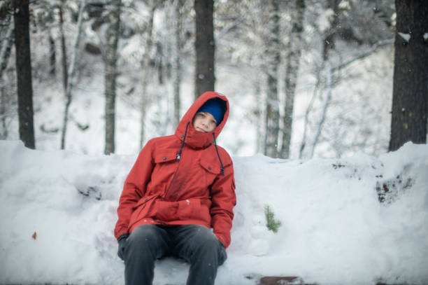istock Boy walking on a snowy winter forest 1430051577